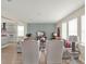 Bright living room featuring comfortable seating, a decorative accent wall, and seamless flow to the kitchen at 565 Big Pine Ave, Minneola, FL 34715