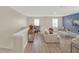 Upstairs living room with contemporary furniture, light-toned wood floors, and a blue accent wall with mounted tv at 565 Big Pine Ave, Minneola, FL 34715