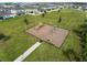 Community playground with swings, slide, and other play structures surrounded by green space at 565 Big Pine Ave, Minneola, FL 34715