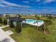 Community pool featuring lounge seating, landscaped surroundings, and a nearby building at 565 Big Pine Ave, Minneola, FL 34715