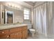 Bathroom featuring a single sink vanity, mirror, and a shower/tub combination with white shower curtain at 620 Wexford Ct, Winter Haven, FL 33884