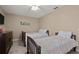 This bedroom features two twin beds, a ceiling fan, and a charming decor, perfect for a room at 620 Wexford Ct, Winter Haven, FL 33884