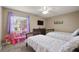 Bright bedroom with twin beds, a dresser, and natural light from the window at 620 Wexford Ct, Winter Haven, FL 33884