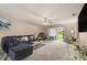 Spacious living room with a large couch, ceiling fan, and sliding glass doors to the exterior at 620 Wexford Ct, Winter Haven, FL 33884