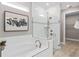 Bathroom featuring a soaking tub with tile surround, glass enclosed shower, and linen closet at 6257 Dew Drop Loop, St Cloud, FL 34771