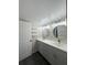 Bathroom with double sink vanity, modern lighting, and shelving at 631 Grenadine Ct # 631, Winter Park, FL 32792