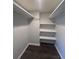 Walk-in closet with built in shelves and hardwood floors at 631 Grenadine Ct # 631, Winter Park, FL 32792