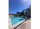 Large community pool with lounge chairs and a clear blue sky, surrounded by palm trees at 631 Grenadine Ct # 631, Winter Park, FL 32792