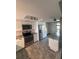 Contemporary kitchen featuring stainless appliances, white cabinets, and mosaic tile backsplash at 631 Grenadine Ct # 631, Winter Park, FL 32792