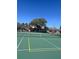 Community tennis court on a sunny day, with view of nearby houses and mature trees at 631 Grenadine Ct # 631, Winter Park, FL 32792