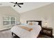 Inviting bedroom with vaulted ceiling, neutral color palette, and a comfortable queen-sized bed at 6992 Brescia Way, Orlando, FL 32819