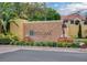 Community entrance sign with Toscana etched in stone and terracotta fountain feature at 6992 Brescia Way, Orlando, FL 32819