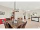 Dining area with a stone table, fireplace, and views to an adjacent room at 6992 Brescia Way, Orlando, FL 32819