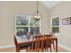 Bright dining room featuring a wooden table, ample natural light, and views of the surrounding landscape at 6992 Brescia Way, Orlando, FL 32819