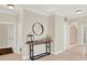 Hallway with tile flooring, a decorative mirror, and modern lighting fixtures at 6992 Brescia Way, Orlando, FL 32819