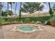 A community hot tub area with lounge chairs and well maintained foliage at 6992 Brescia Way, Orlando, FL 32819