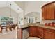 Well-lit kitchen featuring granite countertops, tile floors, and stainless-steel appliances at 6992 Brescia Way, Orlando, FL 32819