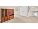 Carpeted loft featuring a wooden cabinet, closet, and railing, and a view into another room at 6992 Brescia Way, Orlando, FL 32819