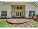 Back patio featuring two chairs and a brick-paved area surrounded by grass and landscaping at 6992 Brescia Way, Orlando, FL 32819