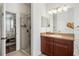 Bathroom with a shower stall featuring glass doors next to the main bedroom in this home at 707 Brandy Oaks Loop, Winter Garden, FL 34787