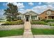 Charming single-story home with manicured lawn and stone accents, showcasing curb appeal and inviting entrance at 707 Brandy Oaks Loop, Winter Garden, FL 34787