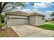 Spacious two car garage with long driveway and neutral exterior at 707 Brandy Oaks Loop, Winter Garden, FL 34787