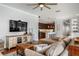 Open-concept living space with hardwood floors and a view into the modern kitchen at 707 Brandy Oaks Loop, Winter Garden, FL 34787