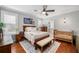 Cozy main bedroom featuring hardwood floors, a ceiling fan, and a comfortable king-sized bed at 707 Brandy Oaks Loop, Winter Garden, FL 34787