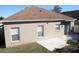 Backyard showing the patio, grass, and windows to the home's interior at 7756 Beridale Ct, Orlando, FL 32818