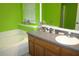 A bathroom shows a bath, sink and vanity, and window at 7756 Beridale Ct, Orlando, FL 32818