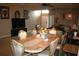 Elegant dining room featuring a large table, decorative furniture, and a view into the living room at 7756 Beridale Ct, Orlando, FL 32818