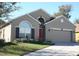 Charming one-story home with a well-maintained lawn, neutral exterior, and red front door at 7756 Beridale Ct, Orlando, FL 32818