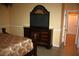 The main bedroom shows a mounted television, dresser, and doorway to another room at 7756 Beridale Ct, Orlando, FL 32818