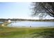 Scenic community pond with fountain and walking path under a clear blue sky at 7756 Beridale Ct, Orlando, FL 32818