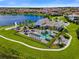 Stunning aerial view of the community clubhouse, pool, lake, and surrounding homes in this vibrant neighborhood at 8742 European Fan Palm Aly, Winter Garden, FL 34787