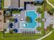 Aerial view of the community pool featuring lounge chairs, tables, fountain, and shaded pergolas at 8742 European Fan Palm Aly, Winter Garden, FL 34787