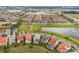 Magnificent aerial view showcasing a mix of houses with pools and townhomes, all surrounded by water features at 8742 European Fan Palm Aly, Winter Garden, FL 34787