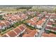 Aerial view of a townhome community with beautiful landscaping, pools, and well-maintained streets at 8742 European Fan Palm Aly, Winter Garden, FL 34787