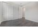 Bedroom features sleek, dark floors, white trim, closet and convenient entry to the hallway at 8742 European Fan Palm Aly, Winter Garden, FL 34787