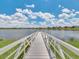 Picturesque wooden dock extending into a calm lake, perfect for peaceful waterfront enjoyment at 8742 European Fan Palm Aly, Winter Garden, FL 34787