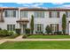 Charming townhome featuring a red tile roof, colorful shutters, and manicured landscaping at 8742 European Fan Palm Aly, Winter Garden, FL 34787