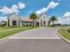 Beautiful two-story home featuring manicured lawns, palm trees, and an elegant circular driveway at 8742 European Fan Palm Aly, Winter Garden, FL 34787