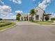 Stunning white two-story home with a well-manicured lawn, lush landscaping, and a circular driveway at 8742 European Fan Palm Aly, Winter Garden, FL 34787