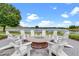 Outdoor fire pit and lounge area surrounded by seating, with a lake in the background at 8742 European Fan Palm Aly, Winter Garden, FL 34787