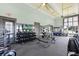 Community gym with full set of weights, weight machines, mirrors and adjacent lake views at 8742 European Fan Palm Aly, Winter Garden, FL 34787