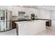 A well-appointed kitchen featuring stainless steel appliances and a large kitchen island at 8742 European Fan Palm Aly, Winter Garden, FL 34787