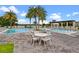 Community pool with lush landscaping, and nearby seating areas offer great views at 8742 European Fan Palm Aly, Winter Garden, FL 34787