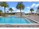 Resort-style pool featuring palm trees, lounge chairs and a covered pergola seating area at 8742 European Fan Palm Aly, Winter Garden, FL 34787