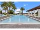 Community zero entry pool with water features, lounge seating and lush tropical landscaping at 8742 European Fan Palm Aly, Winter Garden, FL 34787