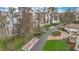 Aerial shot of a home with a circular brick driveway and waterfront access, surrounded by mature trees at 9243 Point Cypress Dr, Orlando, FL 32836